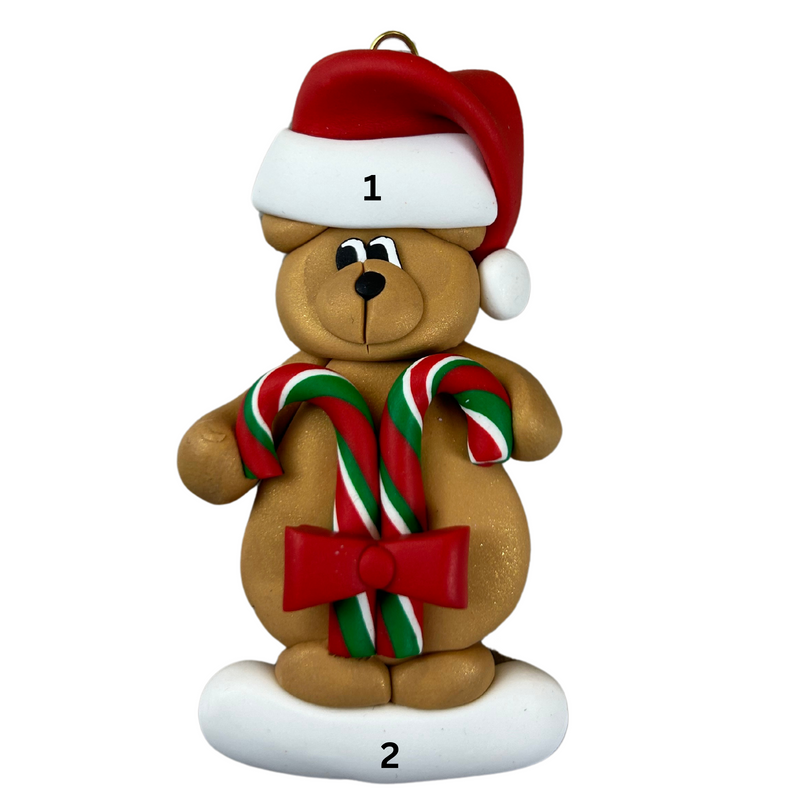 Tan bear in red festive hat holding two candy canes ornament, numbered 1-2 for personalization.