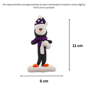 Penguin wearing purple hat and scarf ornament, graphed to show size (5x11cm).