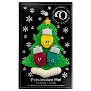 Christmas tree ornament decorated with 3 light bulbs with smiling faces, on display backing card.