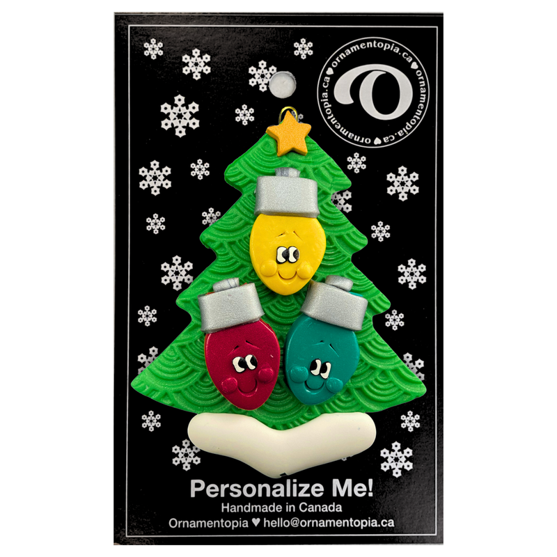 Christmas tree ornament decorated with 3 light bulbs with smiling faces, on display backing card.