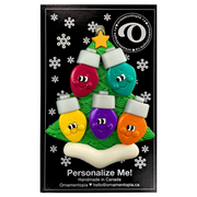 Christmas tree ornament decorated with 5 light bulbs with smiling faces, on display backing card.