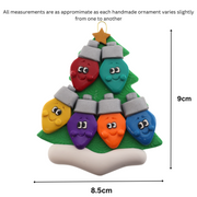 Christmas tree ornament decorated with 6 light bulbs with smiling faces, graphed to show size (8.5x9cm).
