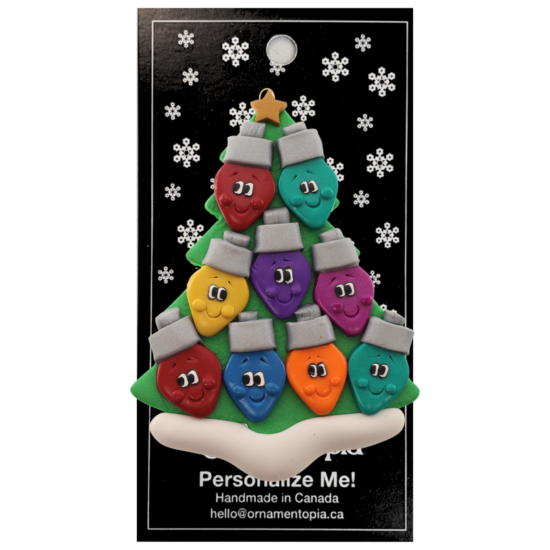 Christmas tree ornament decorated with 9 light bulbs with smiling faces, on display backing card.