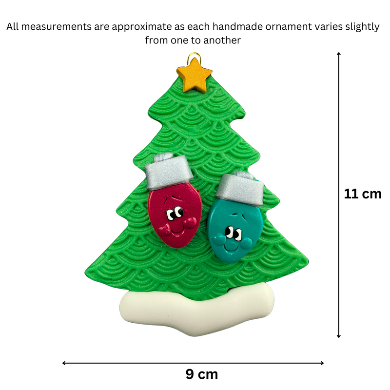 Christmas tree ornament decorated with 2 light bulbs with smiling faces, graphed to show size (9x11cm).