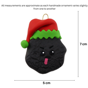 Black frowning lump of coal wearing red festive hat ornament, graphed to show size (5x7cm).