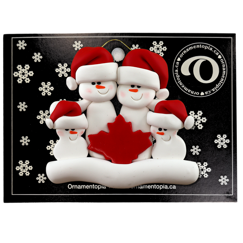 Family ornament with 4 white snowmen in red hats, gathered around a red maple leaf, on display backing card.