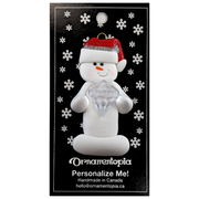 Ornament of white snowman in red hat holding large plastic diamond, on display backing card.