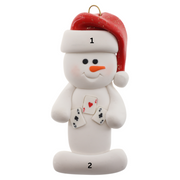Ornament of white snowman in red hat holding several playing cards, numbered 1-2 for personalization.