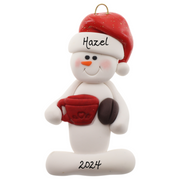 Ornament of white snowman in red hat holding colourful mug and coffee bean, personalized with name.