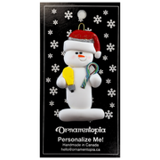 Ornament of white snowman in red hat holding a lightbulb and coil of wire, on display backing card.
