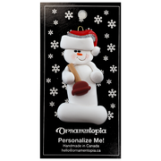 Ornament of white snowman in red hat holding a toilet plunger, on display backing card.