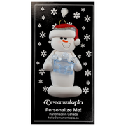 Ornament of white snowman in red hat holding a blue plastic crown, on display backing card.