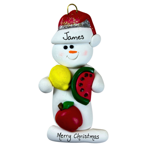 Ornament of white snowman in red hat holding various fruits, personalized with name.