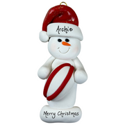 Ornament of white snowman in red hat holding a red and white rugby ball, personalized with name.