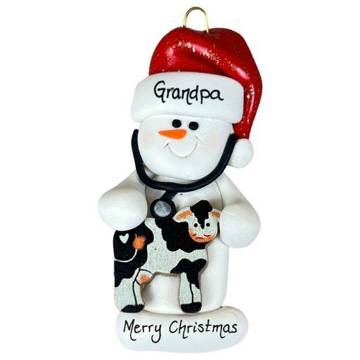 Ornament of white snowman in red hat holding a cow and stethoscope, personalized with name.