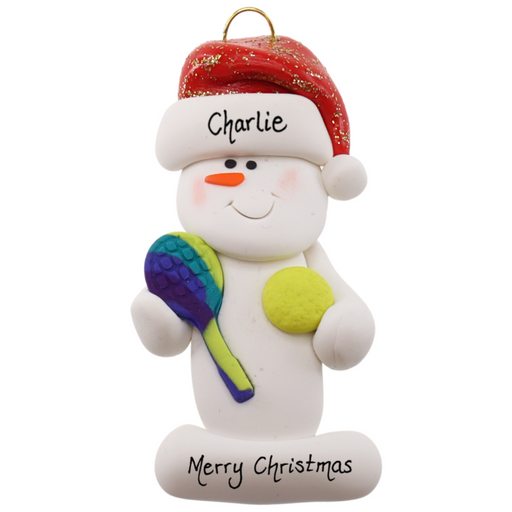 Ornament of white snowman in red hat holding a tennis paddle and ball, personalized with name.