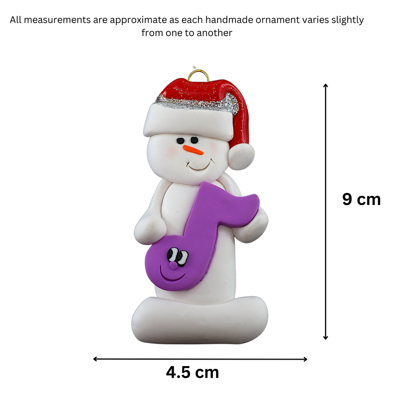 Ornament of white snowman in red hat holding a purple musical note, graphed to show size (4.5x9cm).
