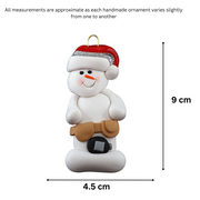 Ornament of white snowman in red hat wearing tool belt with tape measure, graphed to show size (4.5x9cm).