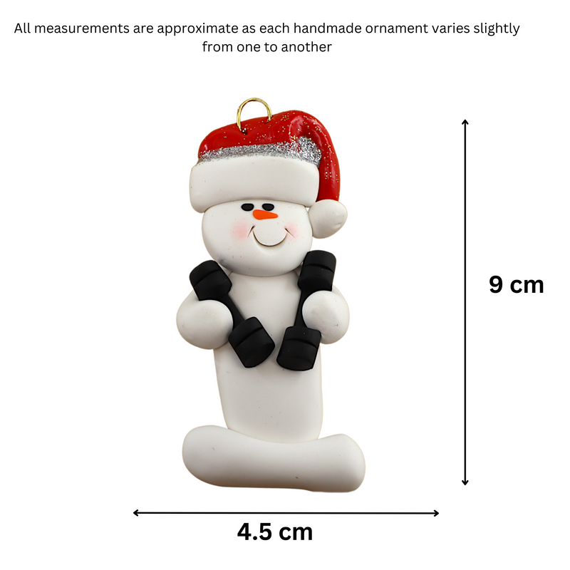 Ornament of white snowman in red hat carrying two dumbbells, graphed to show size (4.5x9cm).