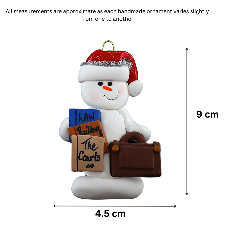 Ornament of white snowman in red hat holding a briefcase and law books, graphed to show size (4.5x9cm).