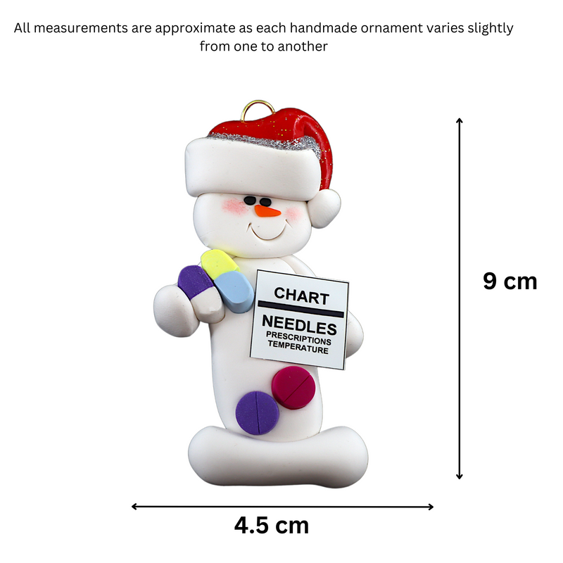 Ornament of white snowman in red hat holding various medications and a medical chart, graphed to show size (4.5x9cm).