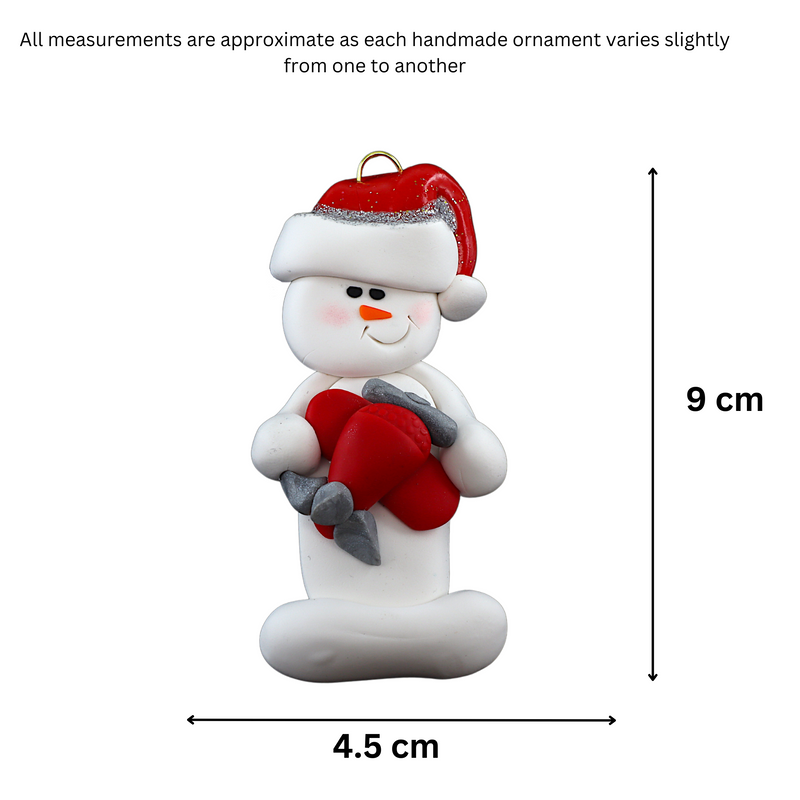 Ornament of white snowman in red hat holding a red airplane, graphed to show size (4.5x9cm).