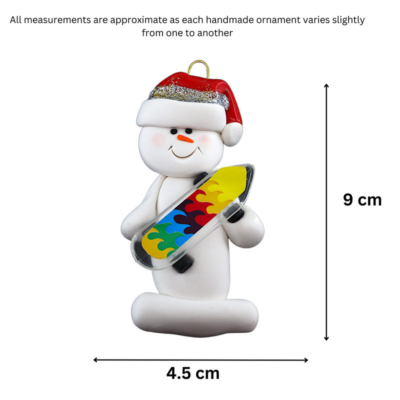 Ornament of white snowman in red hat holding a vibrant skateboard, graphed to show size (4.5x9cm).