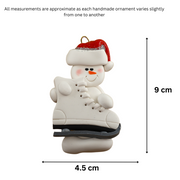 Ornament of white snowman in red hat holding a large white ice skate, graphed to show size (4.5x9cm).