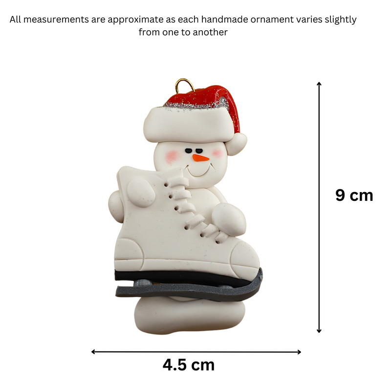 Ornament of white snowman in red hat holding a large white ice skate, graphed to show size (4.5x9cm).