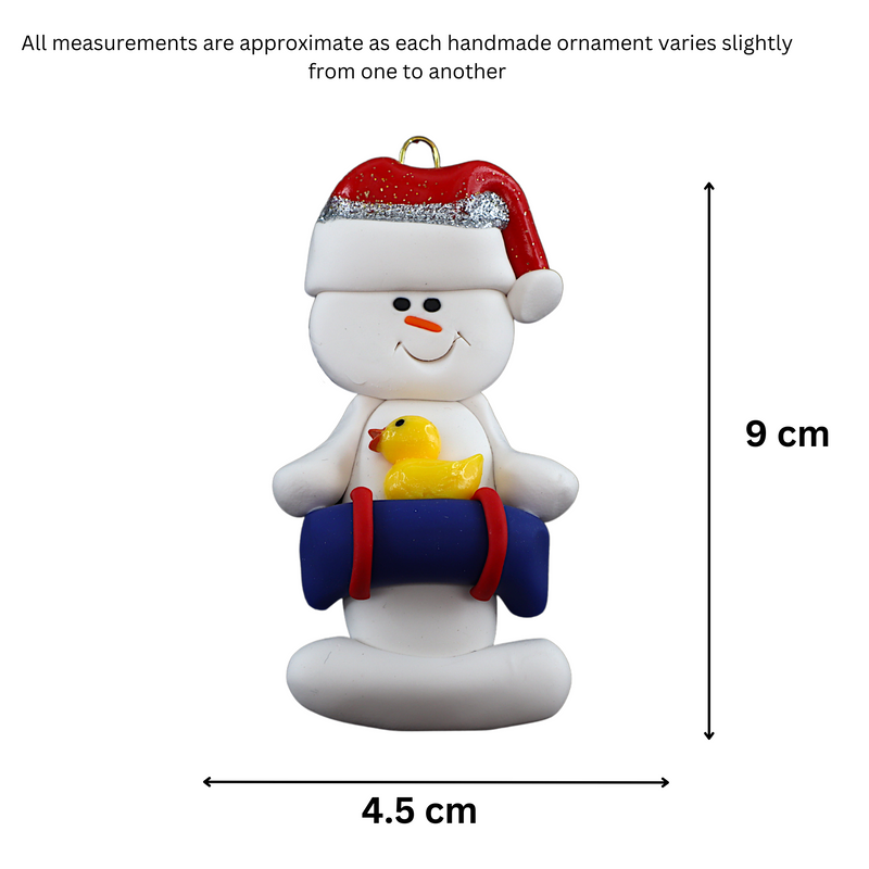 Ornament of white snowman in red hat holding a blue inflatable tube and yellow duck, graphed to show size (4.5x9cm).