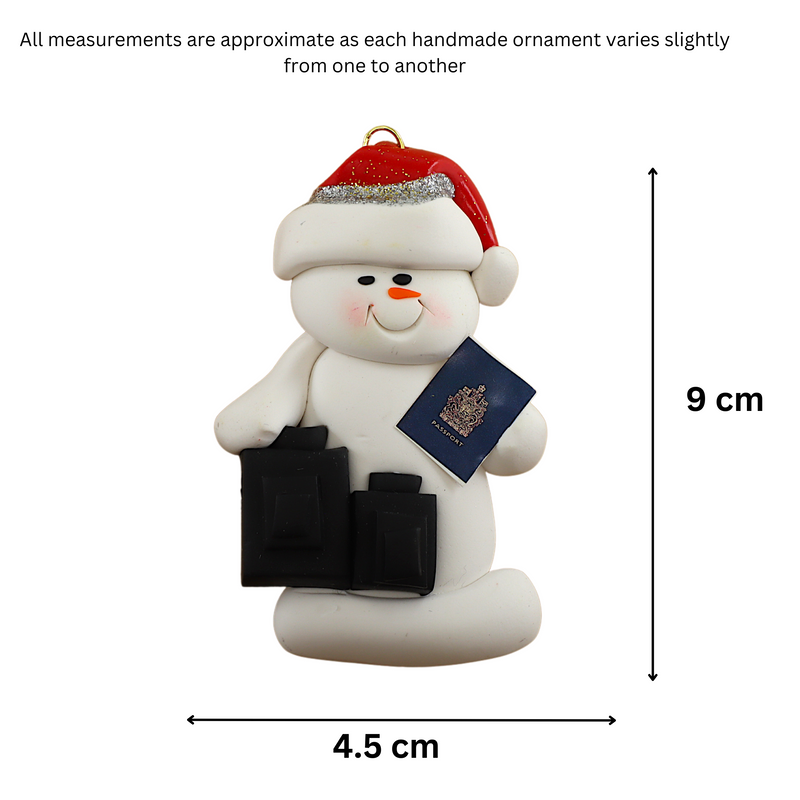 Ornament of white snowman in red hat holding a passport and suitcases, graphed to show size (4.5x9cm).