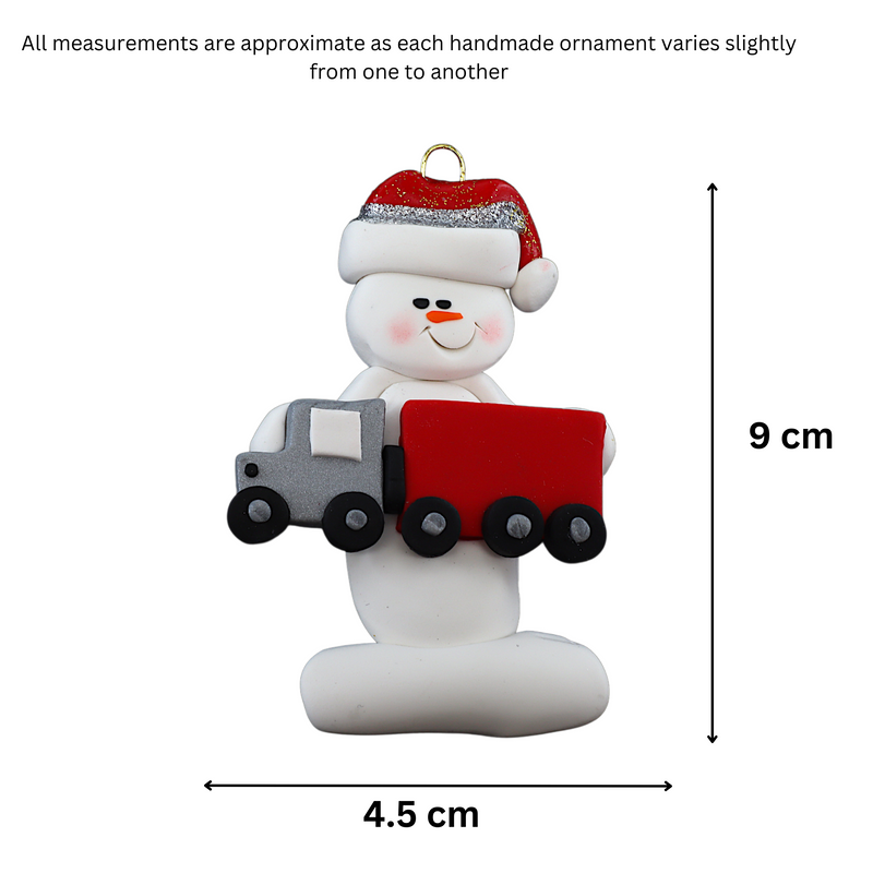 Ornament of white snowman in red hat holding a red semi truck, graphed to show size (4.5x9cm).