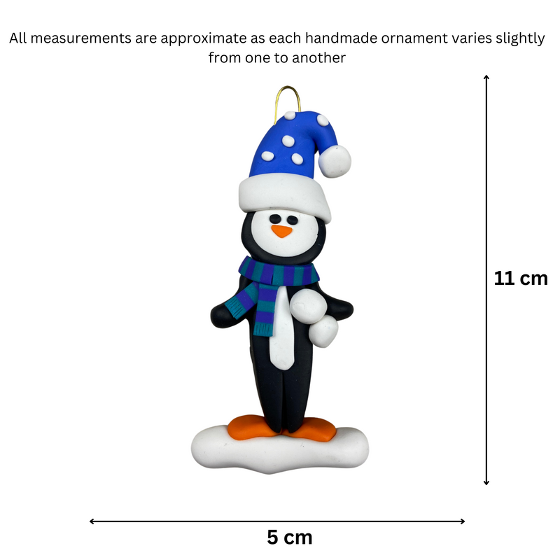 Penguin wearing blue hat and scarf ornament, graphed to show size (5x11cm).