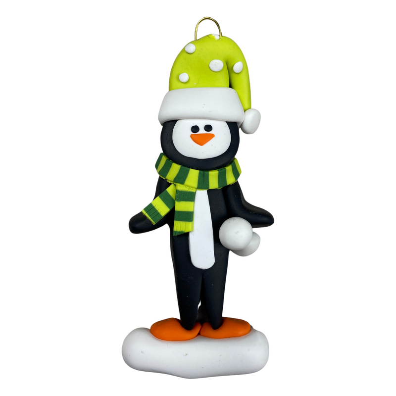 Penguin wearing green hat and scarf ornament.