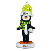 Penguin wearing green hat and scarf ornament, personalized with name.