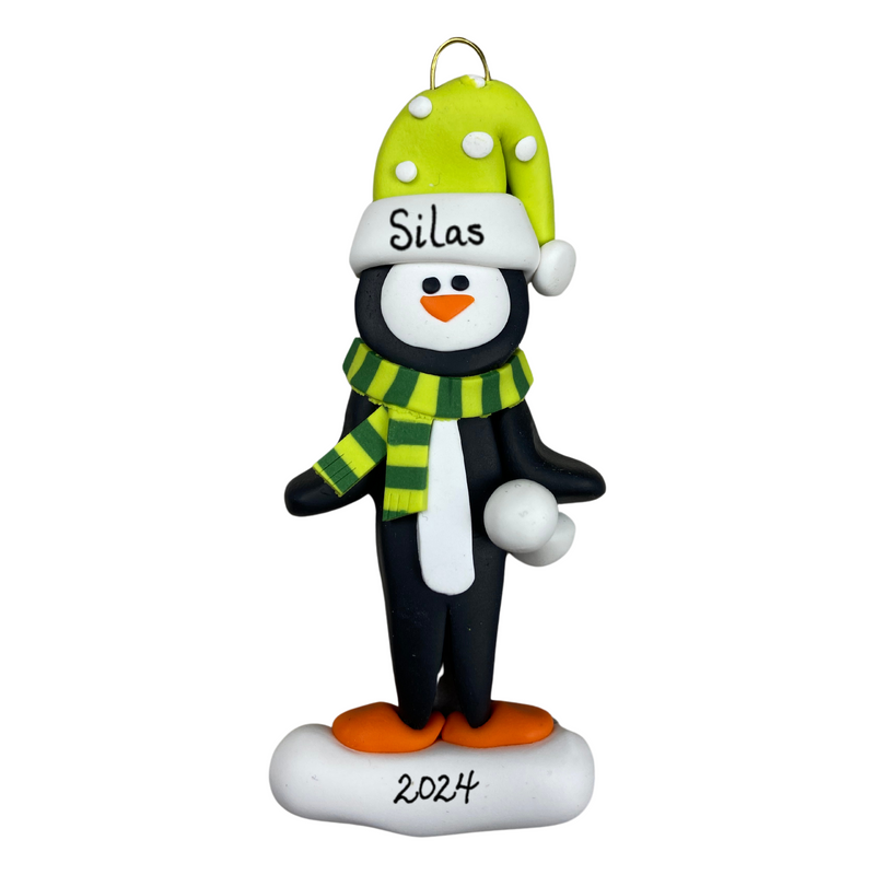 Penguin wearing green hat and scarf ornament, personalized with name.
