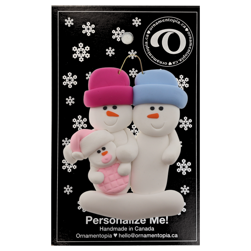 Family ornament with 2 large and 1 infant snowman in pink, on display backing card.