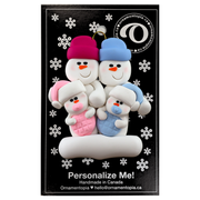 Family ornament with 2 large and 2 infant snowmen in pink and blue, on display backing card.