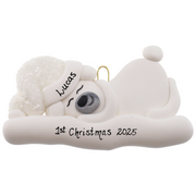 Ornament of white sleeping polar bear baby in a white sparkling hat, personalized with name.