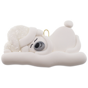 Ornament of white sleeping polar bear baby in a white sparkling hat.