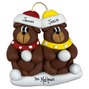 A couple’s ornament of two brown bears in polka dot scarves and hats, personalized with names.
