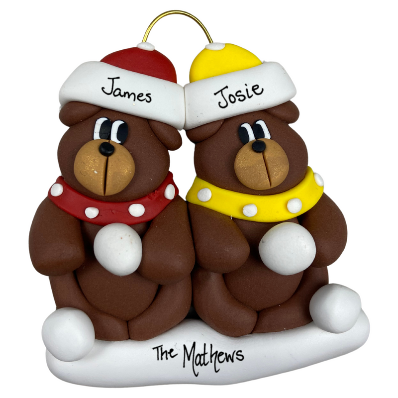 A couple’s ornament of two brown bears in polka dot scarves and hats, personalized with names.
