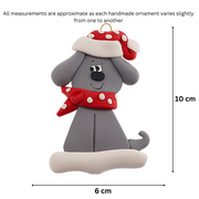 Ornament of grey dog in a red and white polka dot Christmas hat and scarf, graphed to show size (6x10cm).