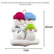 Family ornament with 3 snowmen in bright hats, one pregnant, graphed to show size (7x8.5cm).
