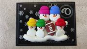 Family ornament with 5 white snowmen in bright hats with a football, shown on backing card and Christmas tree.
