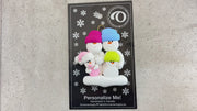 Family ornament with 2 large, 1 small and 1 infant snowman in pink, shown on backing card and Christmas tree.