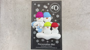 Family ornament with 2 large, 2 small, and 1 infant snowman in blue, shown on backing card and Christmas tree.