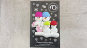 Family ornament with 2 large, 2 small and 1 infant snowman in pink, shown on backing card and Christmas tree.