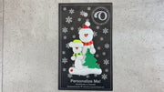 Family ornament with 1 large and 1 small white snowman in bright scarves, with green Christmas tree, shown on backing card and Christmas tree.