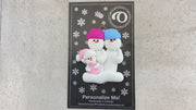 Family ornament with 2 large and 1 infant snowman in pink, shown on backing card and Christmas tree.